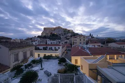 a view of a city with a mountain in the background at ΑΙΘΡΑ Suite in Athens