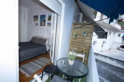 a small room with a table and a bed at ΑΙΘΡΑ Suite in Athens