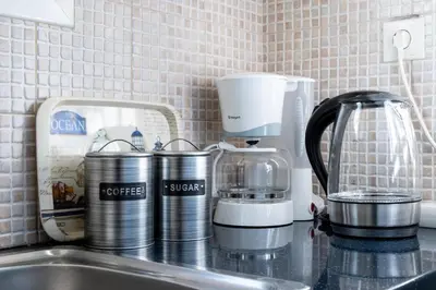 a kitchen counter with a coffeemaker and a coffee maker at Loft Apt with Acropolis View in Athens