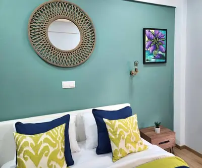 a blue wall with a mirror and a white couch at Victoria Suite VIPGreece in Athens