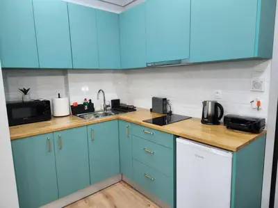 a kitchen with blue cabinets and a sink at Victoria Suite VIPGreece in Athens
