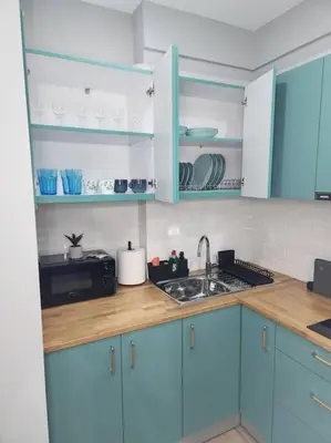 a kitchen with blue cabinets and a sink at Victoria Suite VIPGreece in Athens