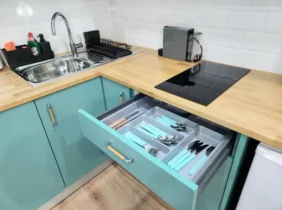 a kitchen with a blue cabinet with an open drawer at Victoria Suite VIPGreece in Athens