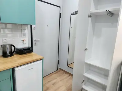 a kitchen with white cabinets and a counter top at Victoria Suite VIPGreece in Athens