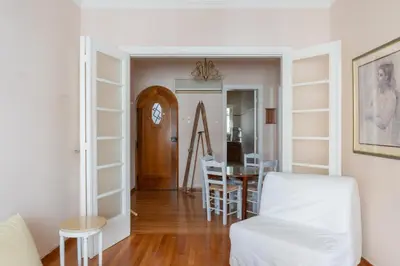a living room with a table and a dining room at Hadrians Den in Heart of Plaka by JJ Hospitality in Athens