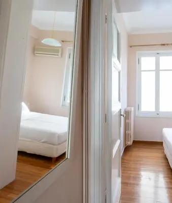 a room with a mirror and a bedroom with a bed at Hadrians Den in Heart of Plaka by JJ Hospitality in Athens