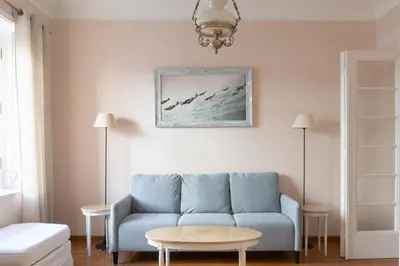 a living room with a blue couch and a table at Hadrians Den in Heart of Plaka by JJ Hospitality in Athens