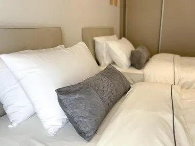 a room with three white pillows on a bed at Anneta’s home in Athens