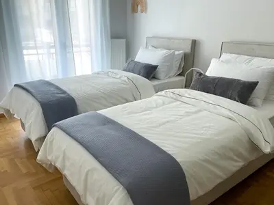 two beds sitting in a room with at Anneta’s home in Athens