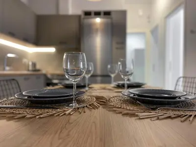 a table with plates and wine glasses on it at Anneta’s home in Athens