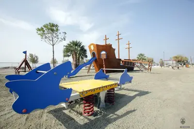 a playground with a slide and a play structure at Palmyra Beach Hotel in Athens