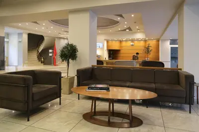a lobby with a couch and a table at Palmyra Beach Hotel in Athens