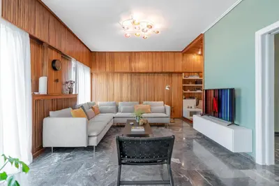 a living room with a couch and a table at Foothills of Acropolis-Thissio 3 bdrm apartment in Athens