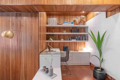 an office with wooden walls and a desk in a room at Foothills of Acropolis-Thissio 3 bdrm apartment in Athens
