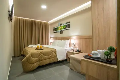 a hotel room with a bed and a table at Argo Hotel Piraeus in Piraeus