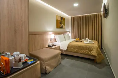 a hotel room with a bed and a table at Argo Hotel Piraeus in Piraeus