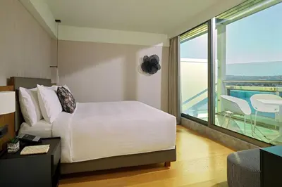 a hotel room with a bed and a balcony at Athens Marriott Hotel in Athens