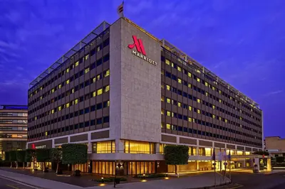 a tall building with a m hotel sign on top at Athens Marriott Hotel in Athens