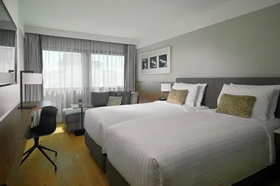 a hotel room with a large bed and a desk at Athens Marriott Hotel in Athens
