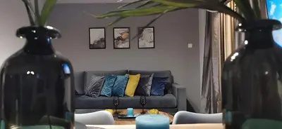 a living room with a couch with pillows on it at Elegant Seaside 2 Floor Apartment in Athens