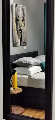 a mirror reflection of a bed in a bedroom at Elegant Seaside 2 Floor Apartment in Athens