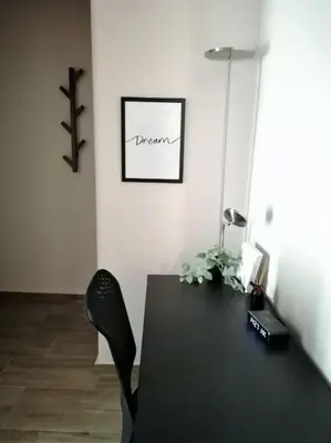 a black table and a black chair in a room at Koukaki cozy apartment 5 minutes to metro in Athens
