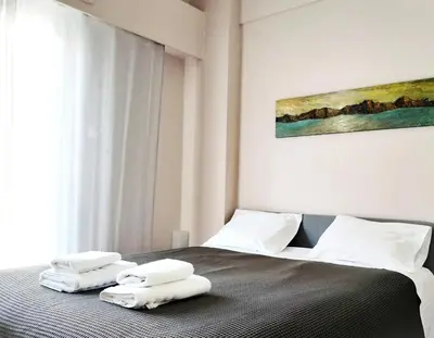 a bedroom with a bed with two towels on it at Koukaki cozy apartment 5 minutes to metro in Athens