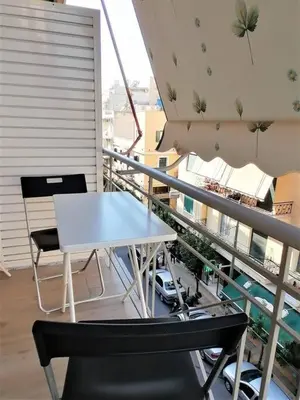 a white table and chairs on a balcony at Koukaki cozy apartment 5 minutes to metro in Athens