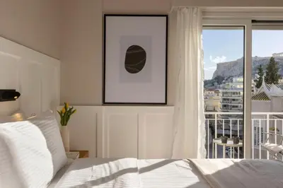 a bedroom with a bed and a large window at Meliti Apartment in Plaka in Athens