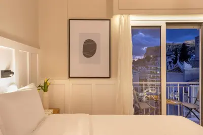 a bedroom with a bed and a window with a view at Meliti Apartment in Plaka in Athens