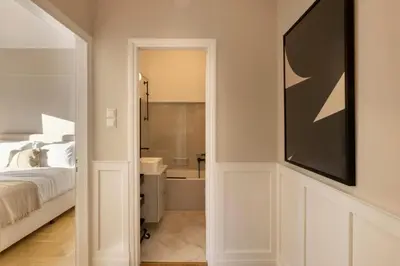 a bedroom with a bed and a bathroom at Meliti Apartment in Plaka in Athens
