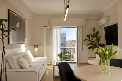 a living room with a white couch and a table at Meliti Apartment in Plaka in Athens