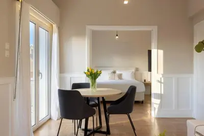 a room with a bed and a table with chairs at Meliti Apartment in Plaka in Athens