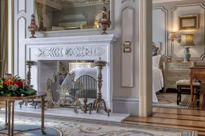 a living room with a fireplace and a bedroom at Hotel Grande Bretagne, a Luxury Collection Hotel, Athens in Athens