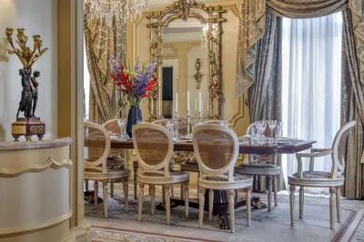 a dining room with a table and chairs and a mirror at Hotel Grande Bretagne, a Luxury Collection Hotel, Athens in Athens
