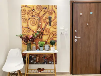 a room with a table with a clock and a door at near Acropolis new 2 bedrooms apt in Koukaki in Athens