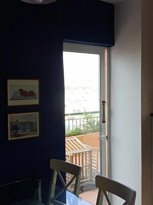 a room with two chairs and a door to a balcony at Full Acropolis View Apartment in Athens