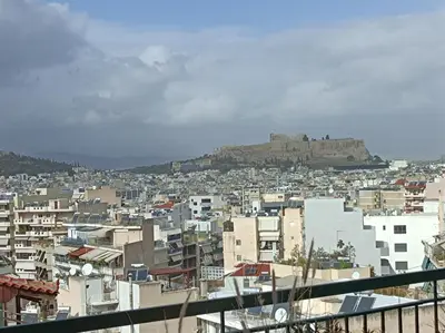 a view of a city with a hill in the background at Full Acropolis View Apartment in Athens