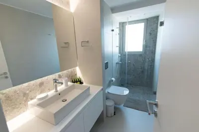 a white bathroom with a sink and a toilet at New-built apartment close to Athens city centre (Form_E1) in Athens