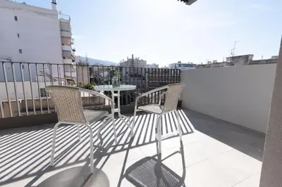 a patio with two chairs and a table on a balcony at New-built apartment close to Athens city centre (Form_E1) in Athens
