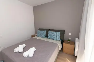 a small bedroom with a bed with towels on it at Modern apartment close to Athens city center (Form_F2) in Athens