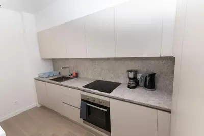 a kitchen with white cabinets and a counter top at Modern apartment close to Athens city center (Form_F2) in Athens