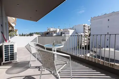 a patio with a table and chairs on a balcony at Modern apartment close to Athens city center (Form_F2) in Athens