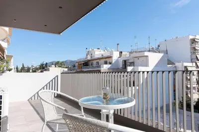 a balcony with a table and chairs on a balcony at Modern apartment close to Athens city center (Form_F2) in Athens