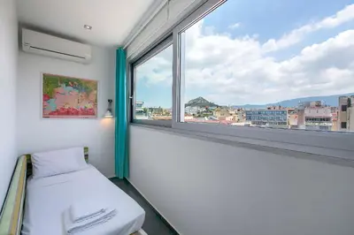 a room with a bed and a large window at Acropolis Panorama View Penthouse with Private Terraces A Contemporary Parthenon in Athens