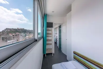 a room with a window with a view of a city at Acropolis Panorama View Penthouse with Private Terraces A Contemporary Parthenon in Athens