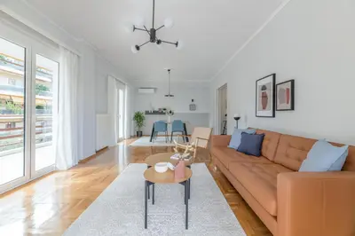 a living room with a couch and a table at Homey 2BR Apartment in Cholargos by UPSTREET in Athens
