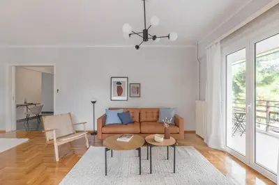 a living room with a couch and a table at Homey 2BR Apartment in Cholargos by UPSTREET in Athens