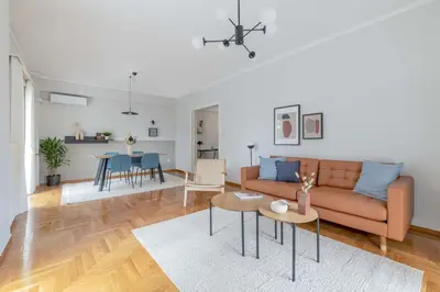 a living room with a couch and a table at Homey 2BR Apartment in Cholargos by UPSTREET in Athens