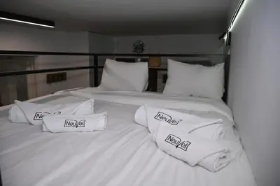 a large white bed with white pillows on it at Urban Loft by Neuvel in Athens